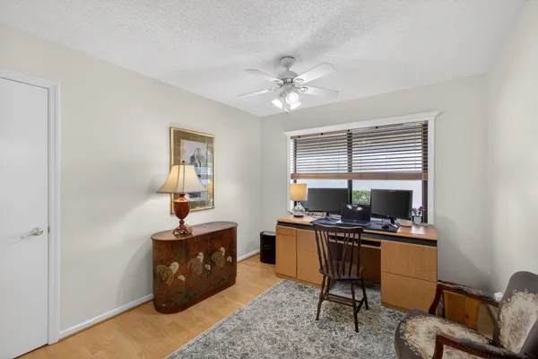 a view of a workspace with furniture and a window