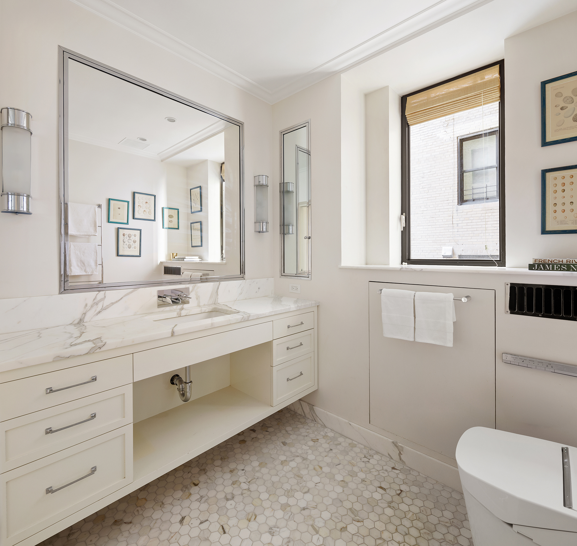 10 Gracie Square, Unit 8D Manhattan, NY 10028 - Photo 14 of 20 a spacious bathroom with a granite countertop sink toilet a large mirror and a window