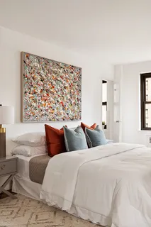 a bedroom with a large bed and a couch