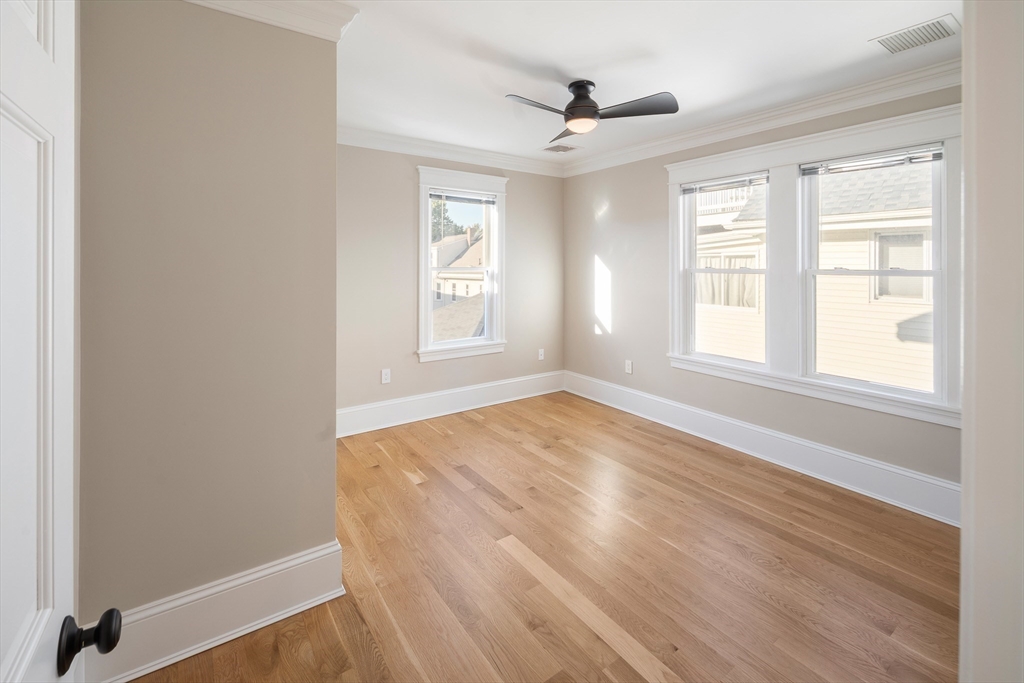 48-50 Amsden Street, Unit 2 Arlington, MA 02474 - Photo 18 of 34 an empty room with wooden floor and windows