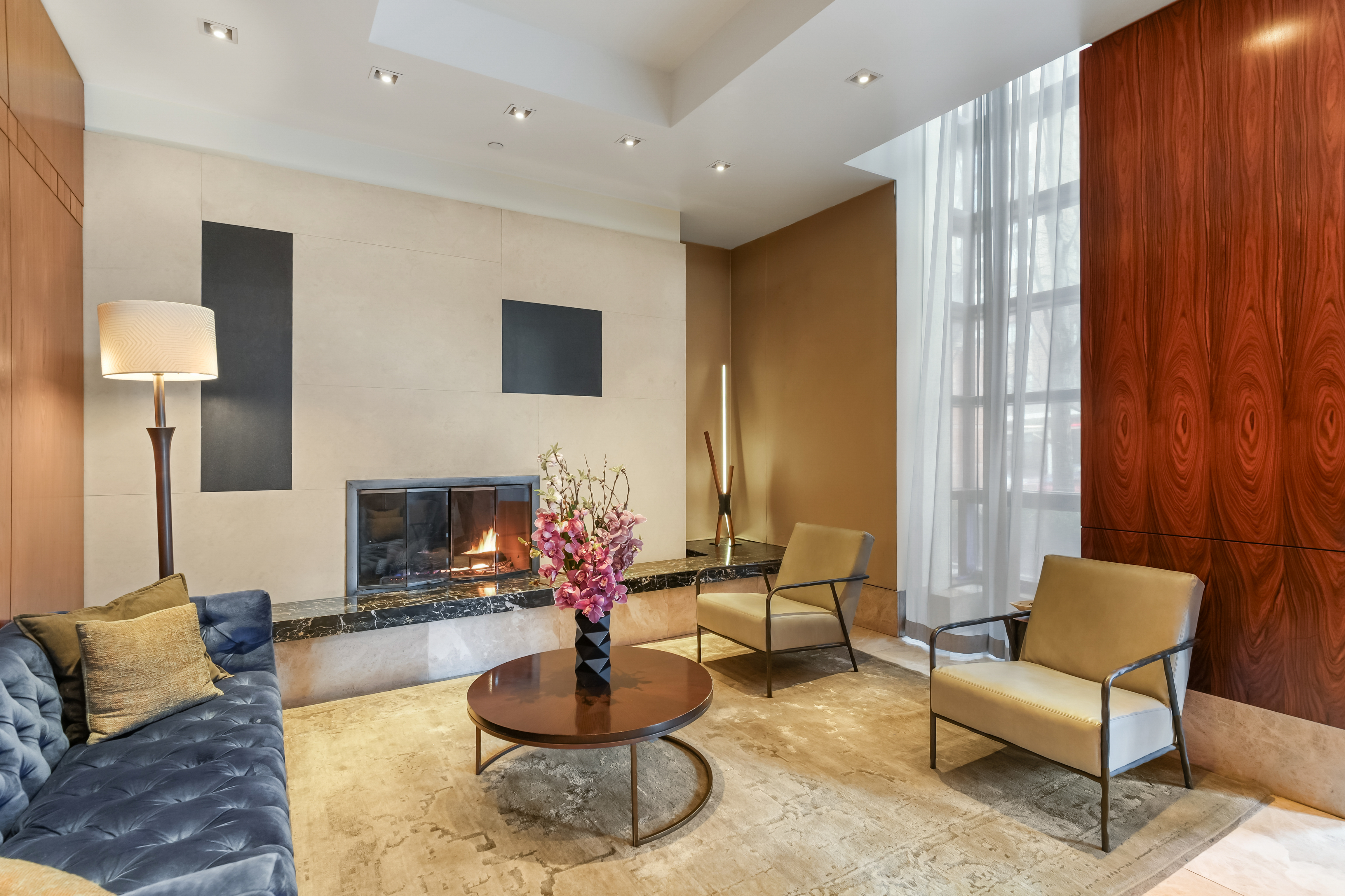 215-217 East 96th Street, Unit 32F Manhattan, NY 10128 - Photo 7 of 8 a living room with furniture and a fireplace