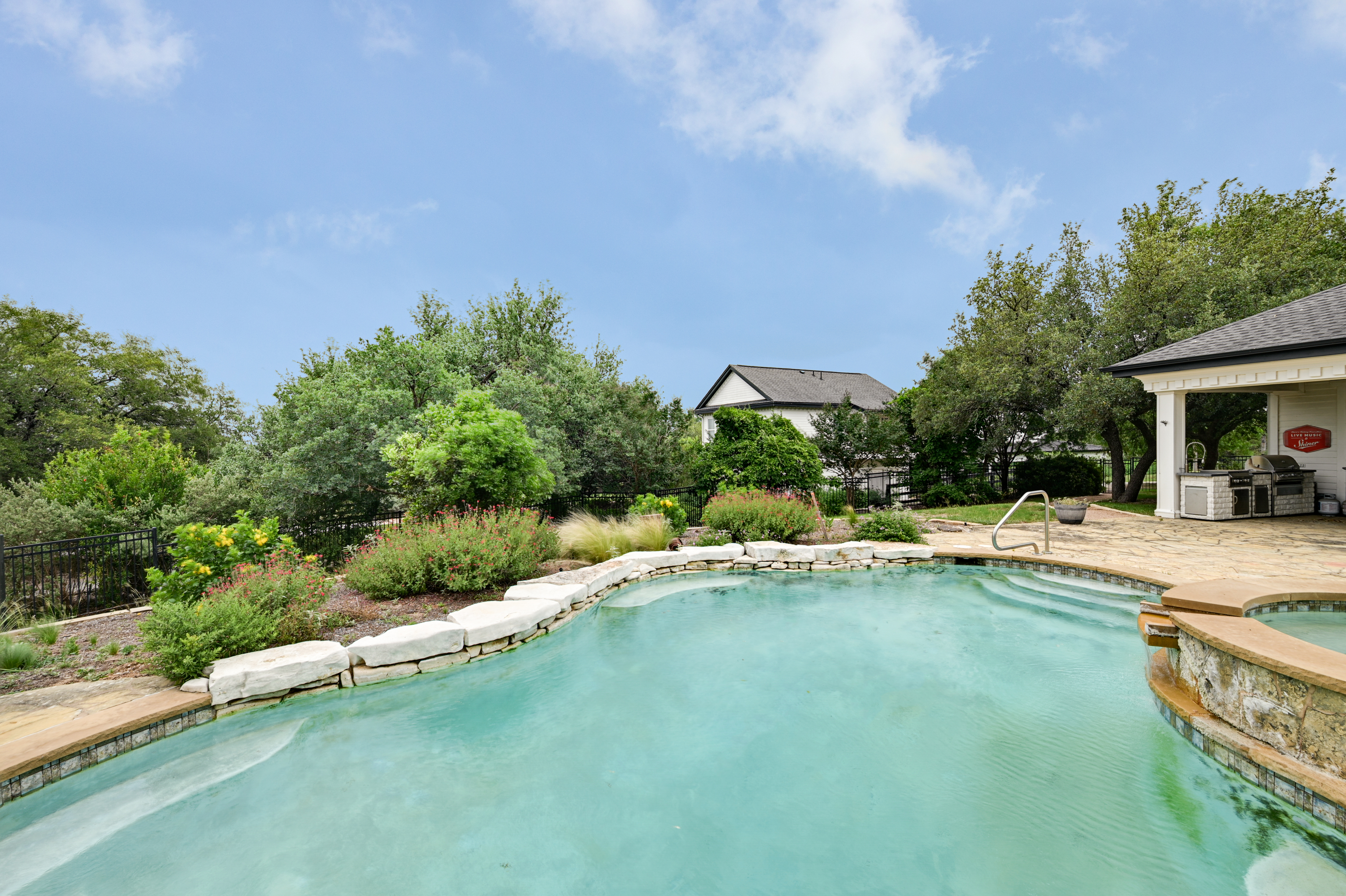 14913 Murfin Road Austin, TX 78734 - Photo 20 of 40 a view of a house with swimming pool and sitting area