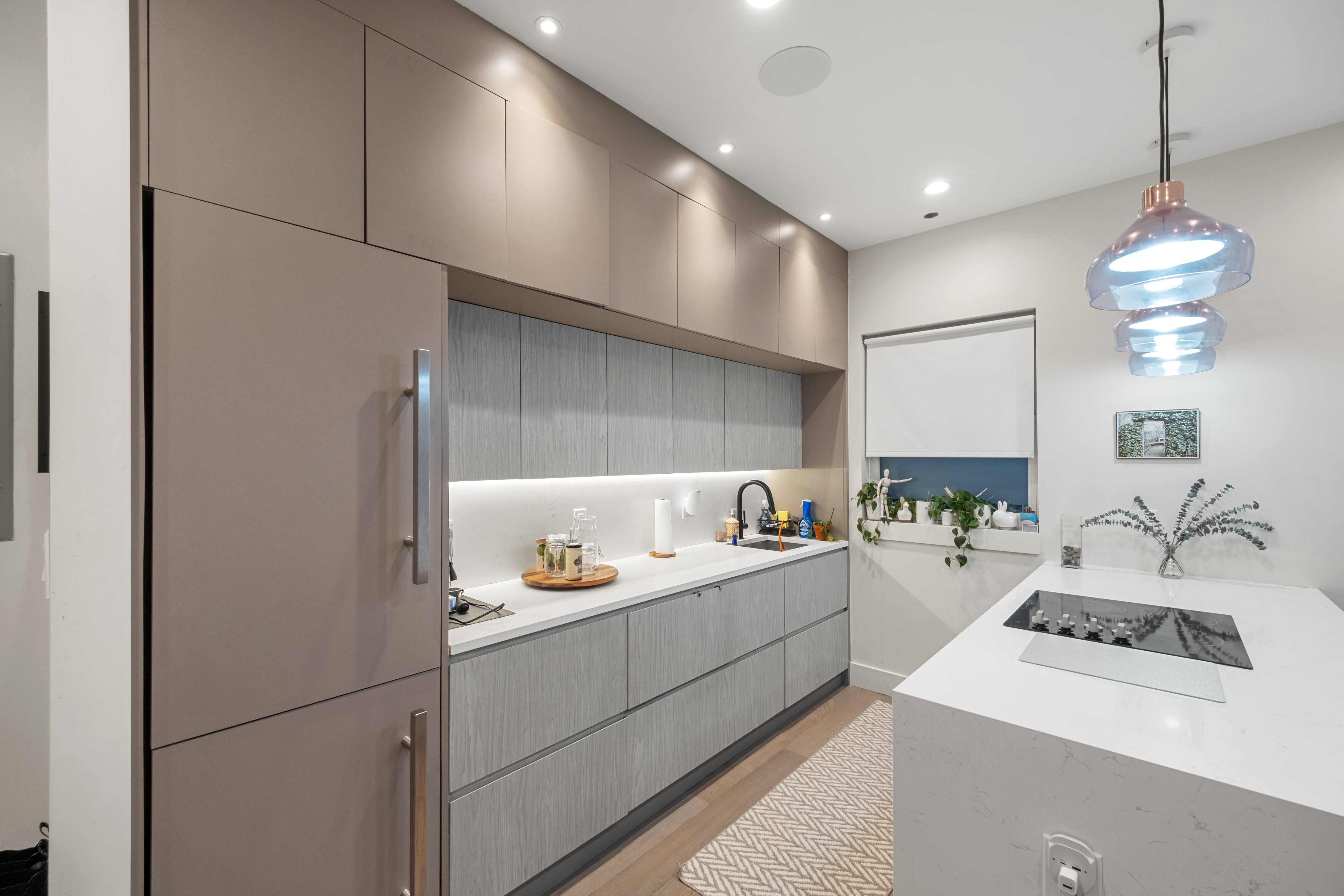 394 Harman Street, Unit 1B Brooklyn, NY 11237 - Photo 3 of 23 a kitchen with a sink and refrigerator