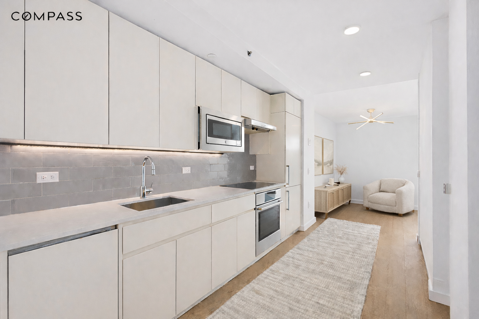 1790 3rd Avenue, Unit 1004 Manhattan, NY 10029 - Photo 4 of 9 a kitchen with stainless steel appliances granite countertop a sink a stove and a refrigerator