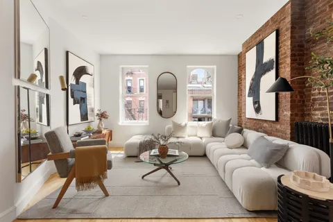 a living room with furniture fireplace and a large window