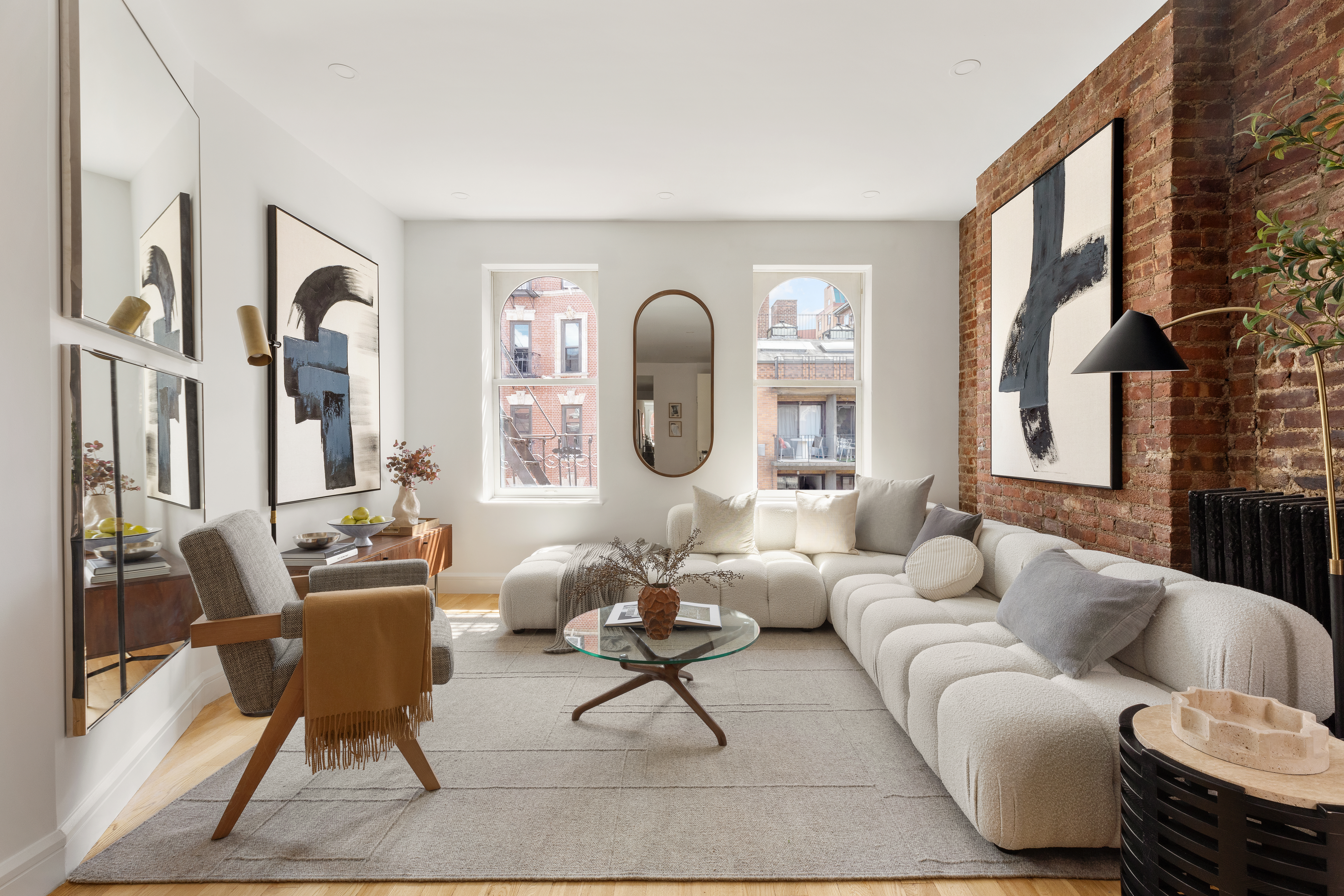 a living room with furniture fireplace and a large window