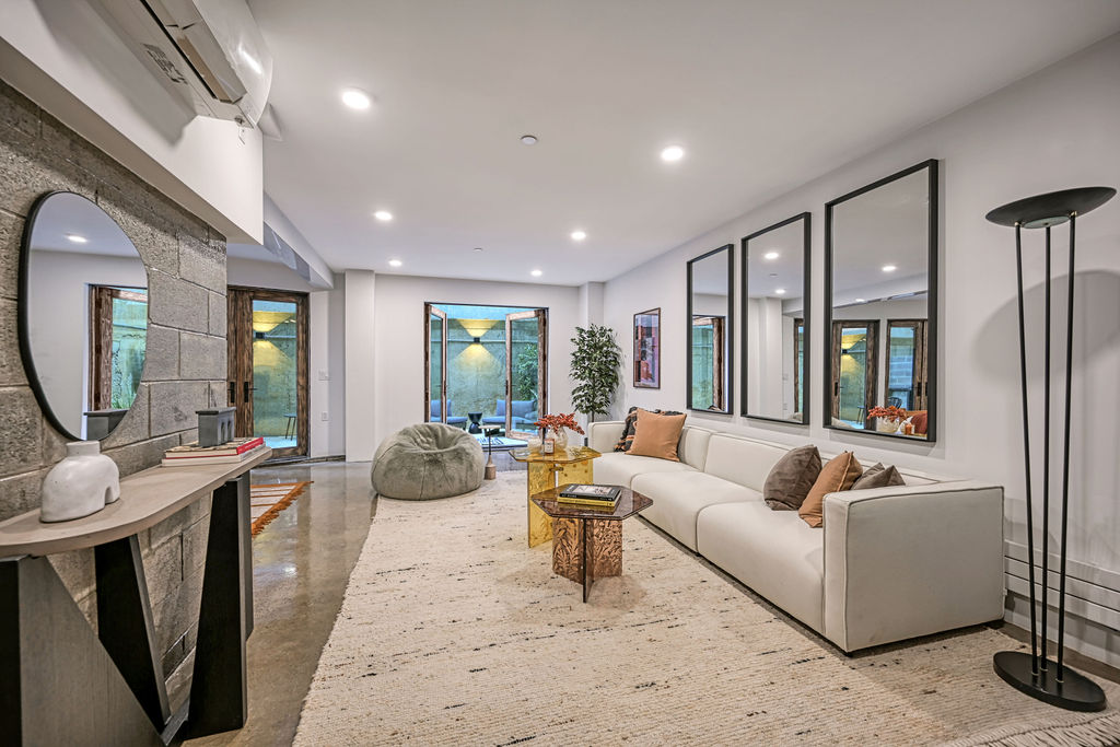 459 Harman Street, Unit 1 Manhattan, NY 10026 - Photo 11 of 17 a living room with furniture fireplace and large windows