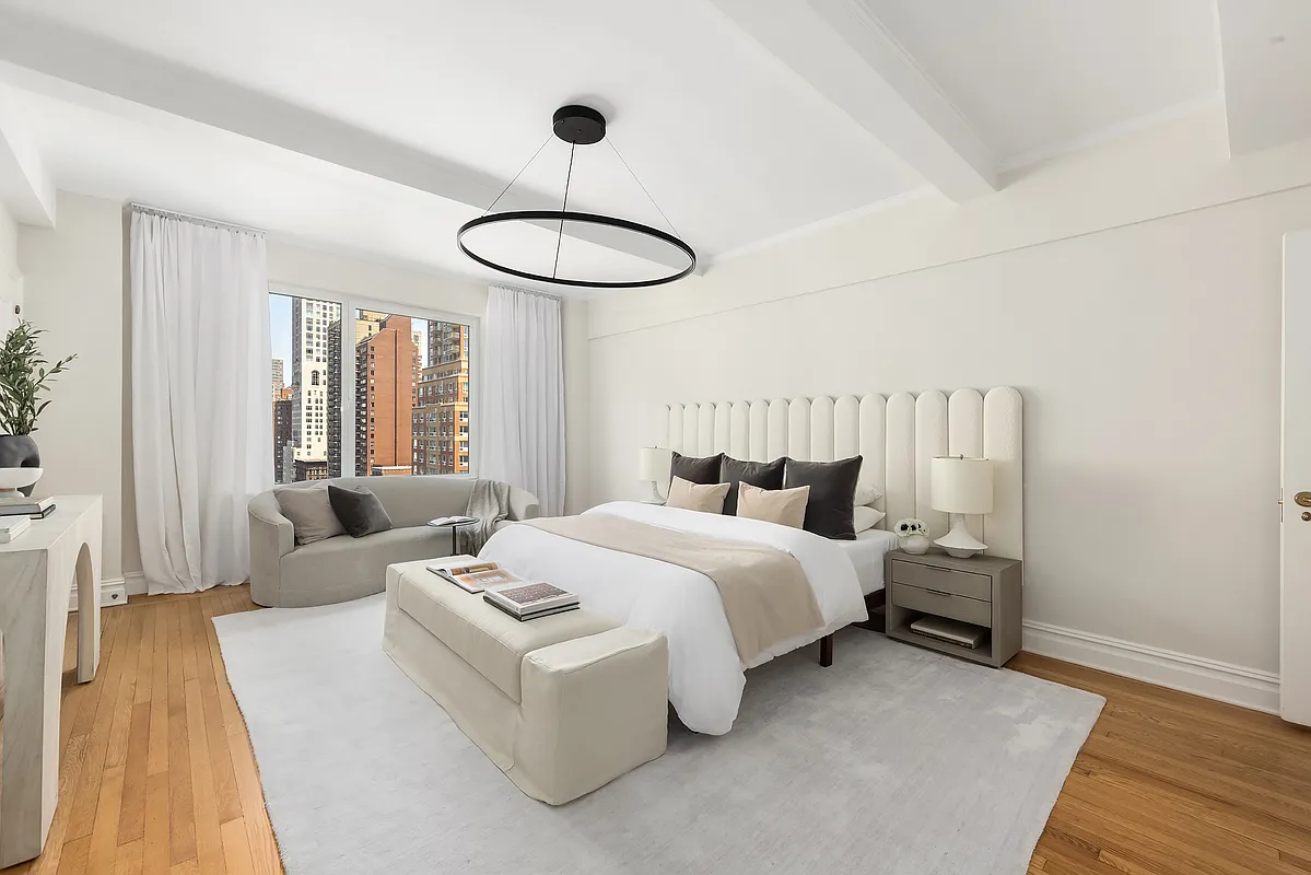 180 East 79th Street, Unit 14B Manhattan, NY 10075 - Photo 14 of 18 a spacious bedroom with a bed and wooden floor