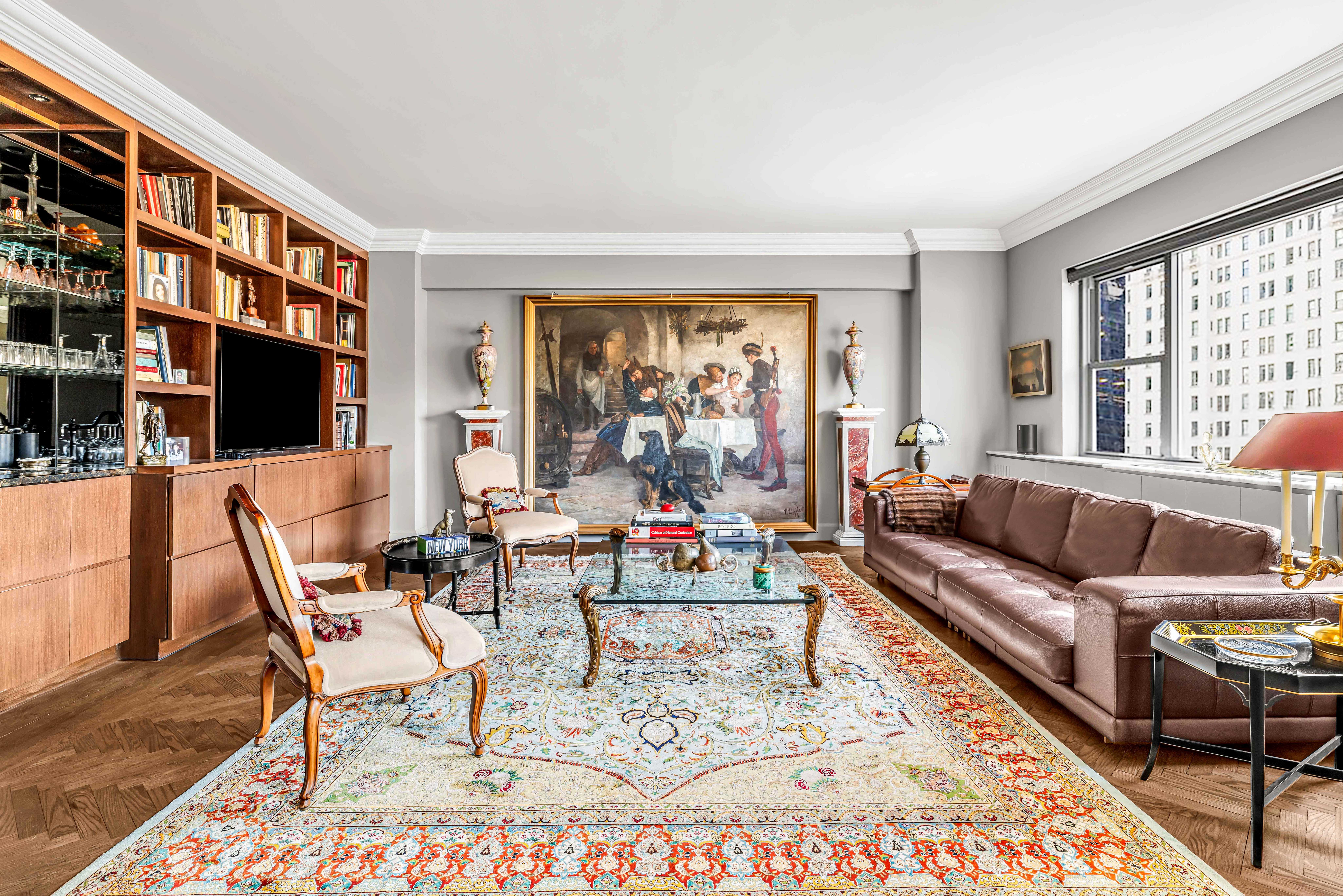 785 5th Avenue, Unit 3C Manhattan, NY 10022 - Photo 4 of 16 a living room with furniture and a flat screen tv