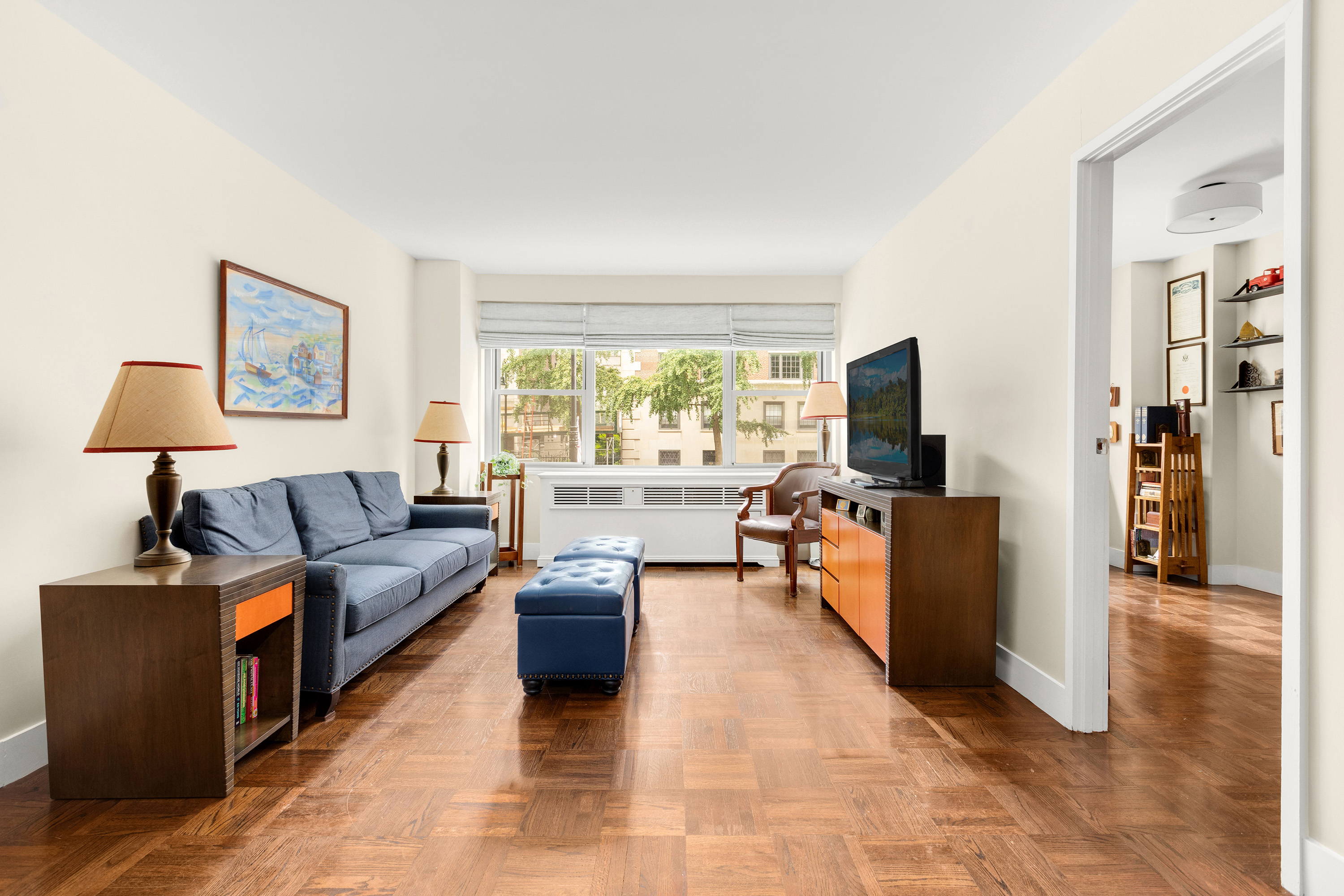 525 East 86th Street, Unit 2G Manhattan, NY 10028 - Photo 2 of 12 a living room with furniture and a flat screen tv