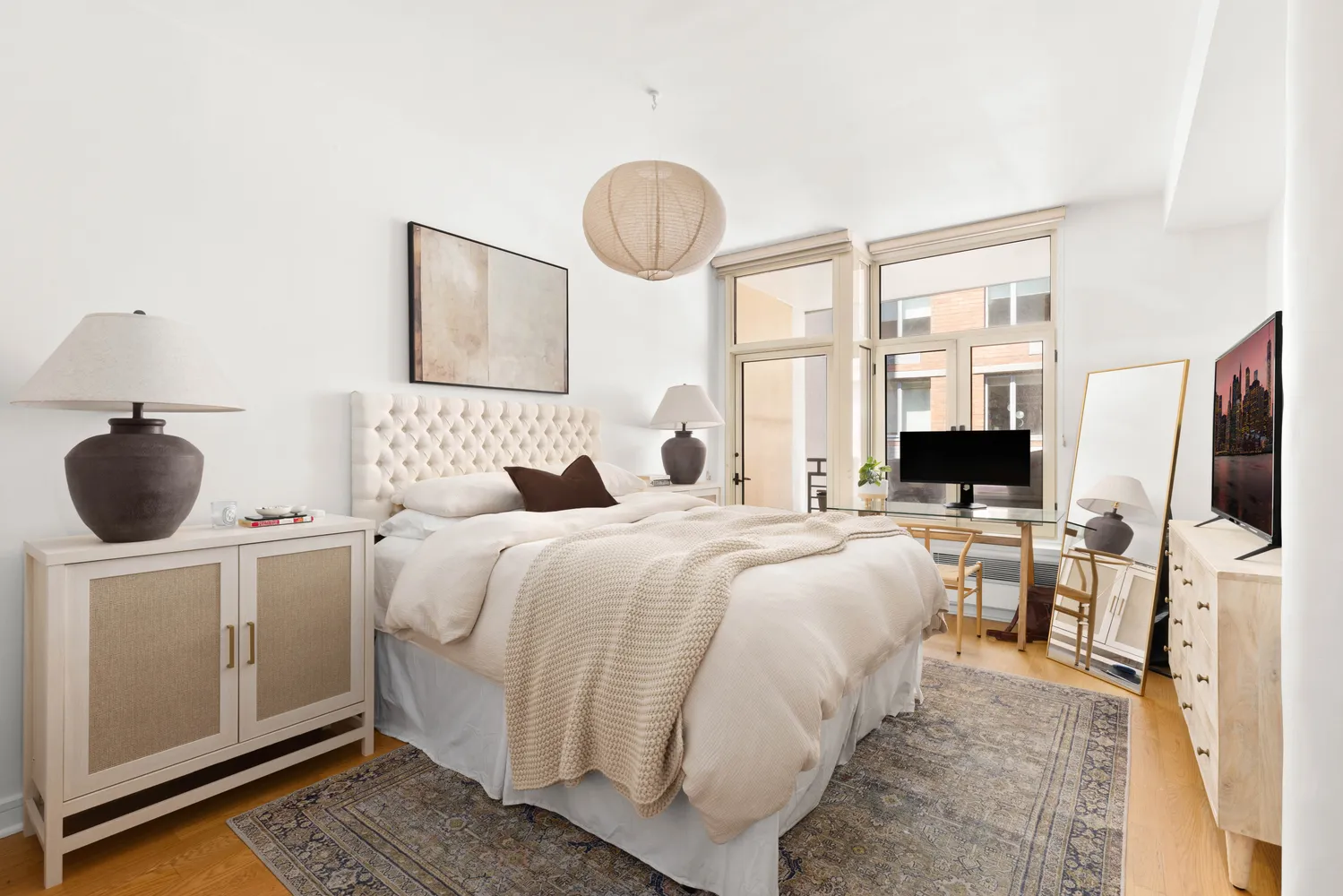 a bedroom with a bed and a flat screen tv