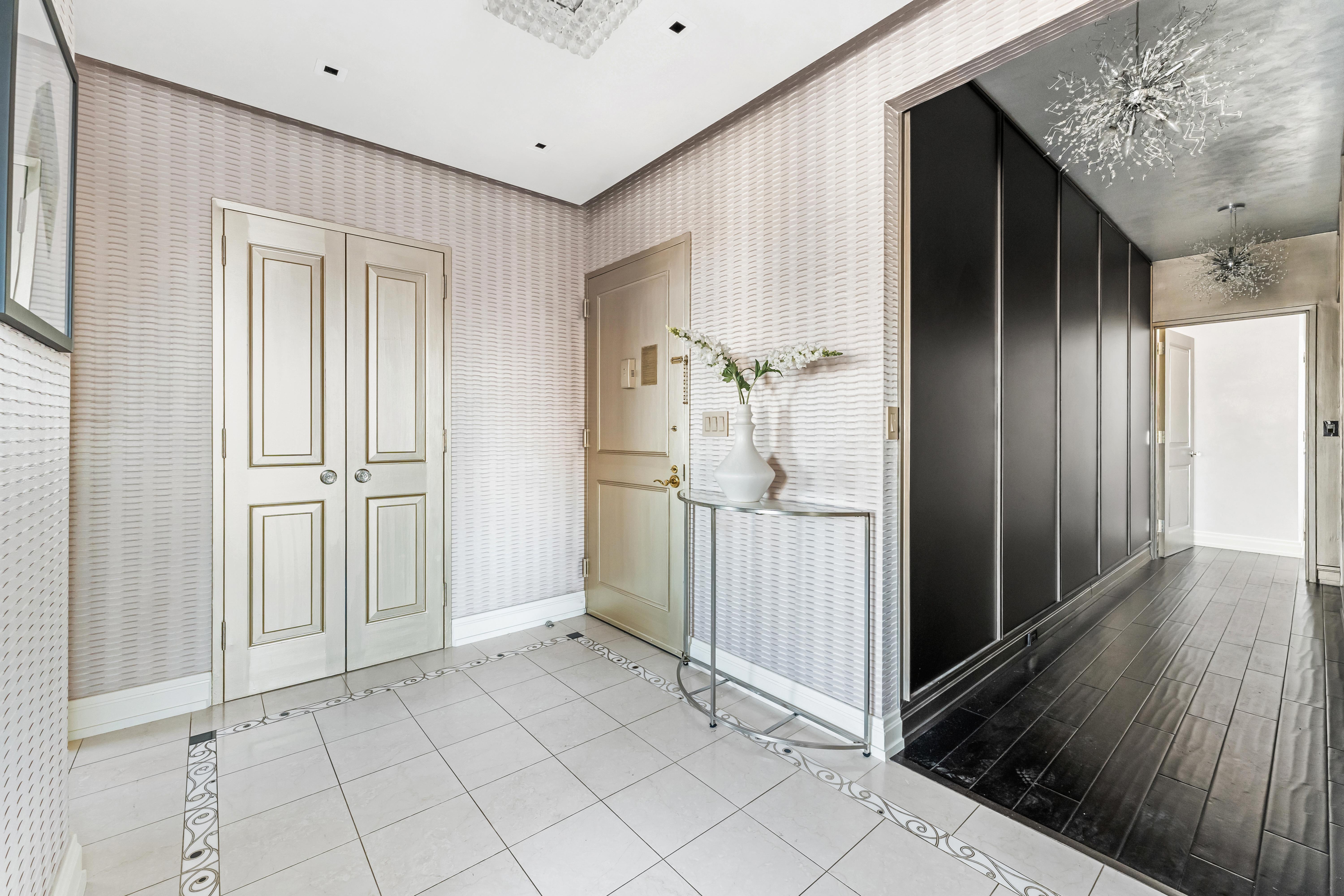 400 East 90th Street, Unit 23B Manhattan, NY 10128 - Photo 15 of 17 a view of a hallway with wooden floor and staircase