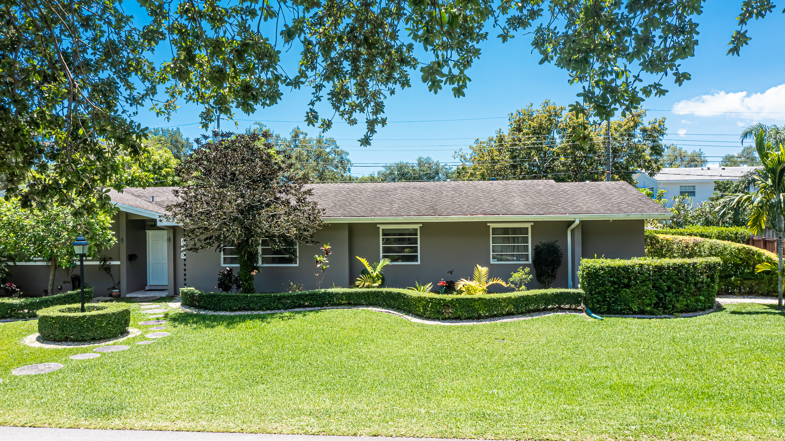6760 Southwest 62nd Terrace Miami, FL 33143 - Photo 3 of 38 a front view of house with yard and green space