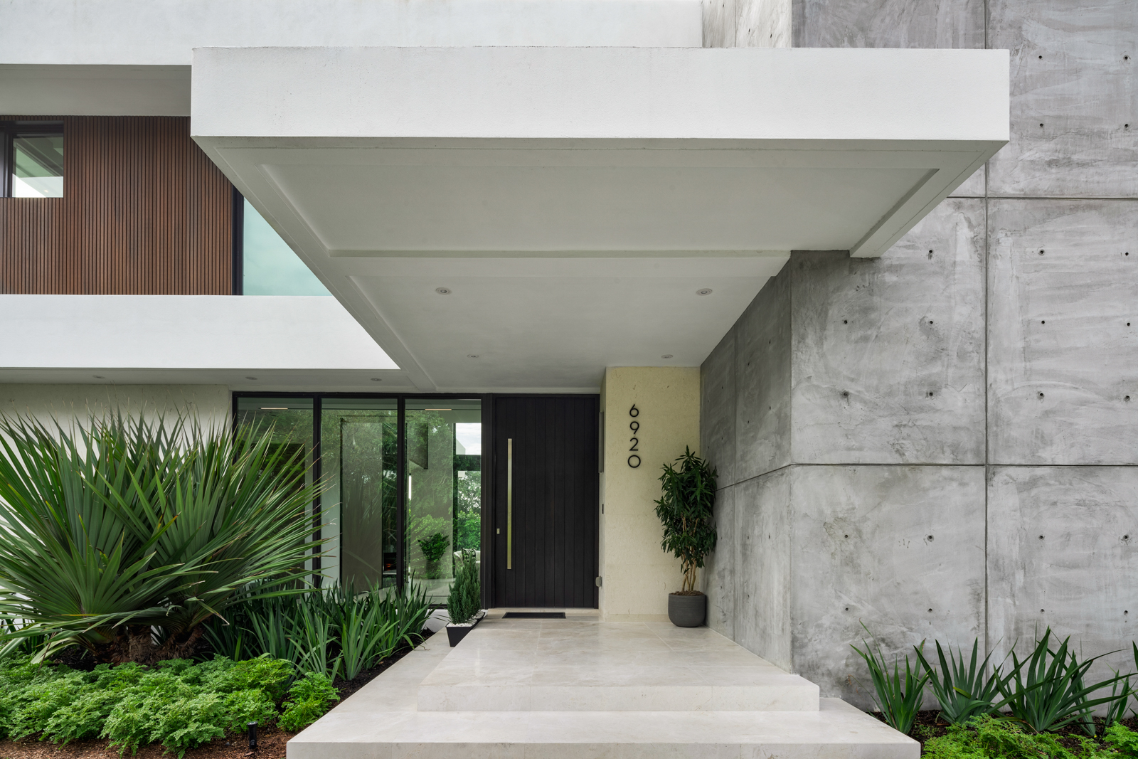 6920 Southwest 124th Street Pinecrest, FL 33156 - Photo 2 of 48 a potted plant sitting in front of a building