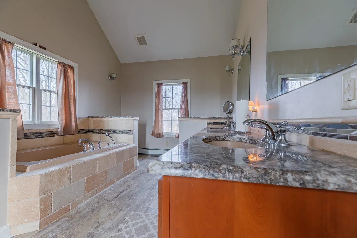 a view of a multi story yard with plants and large trees