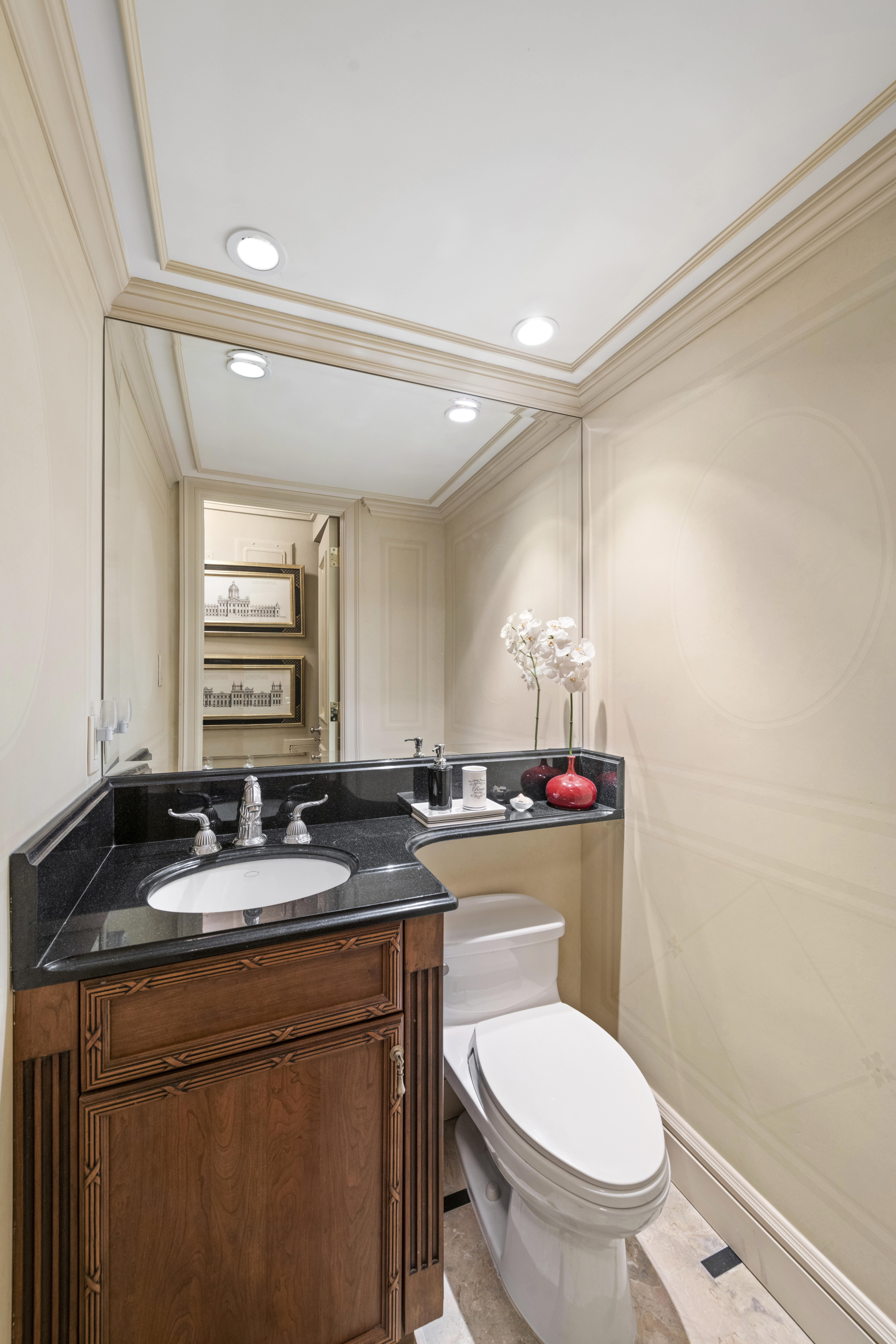 169 East 69th Street, Unit 7/8 B Manhattan, NY 10021 - Photo 11 of 30 a bathroom with a granite countertop toilet sink and mirror