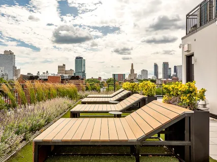 a view of a roof deck with chair and wooden floor