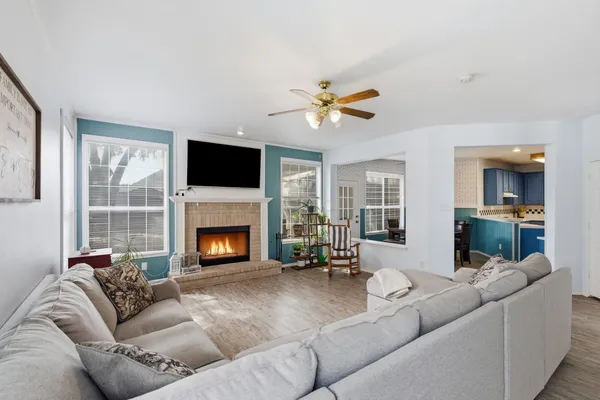 a living room with furniture a fireplace and a flat screen tv