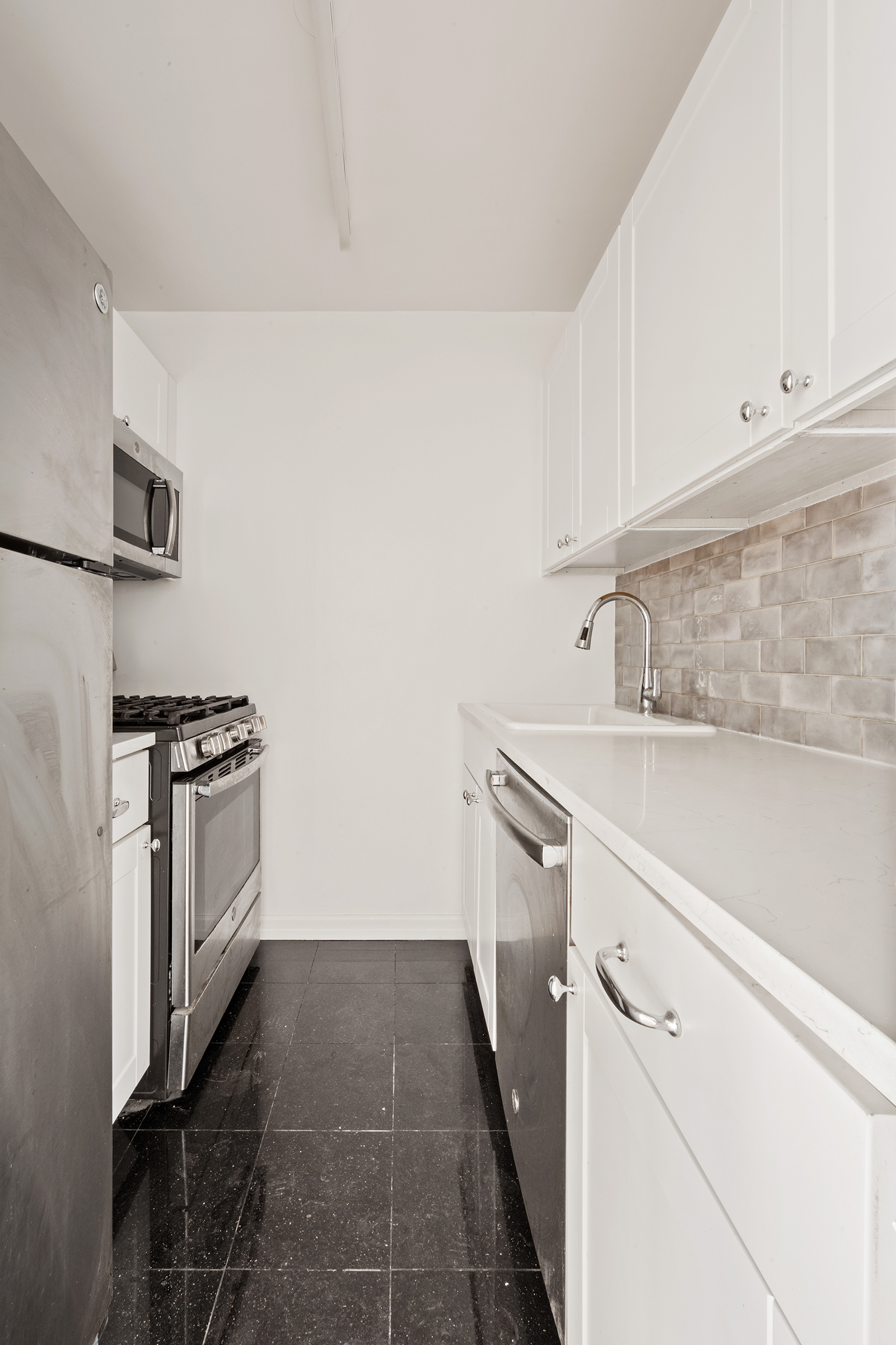 137 East 36th Street, Unit 11D Manhattan, NY 10016 - Photo 4 of 12 a kitchen with a sink and a stove top oven
