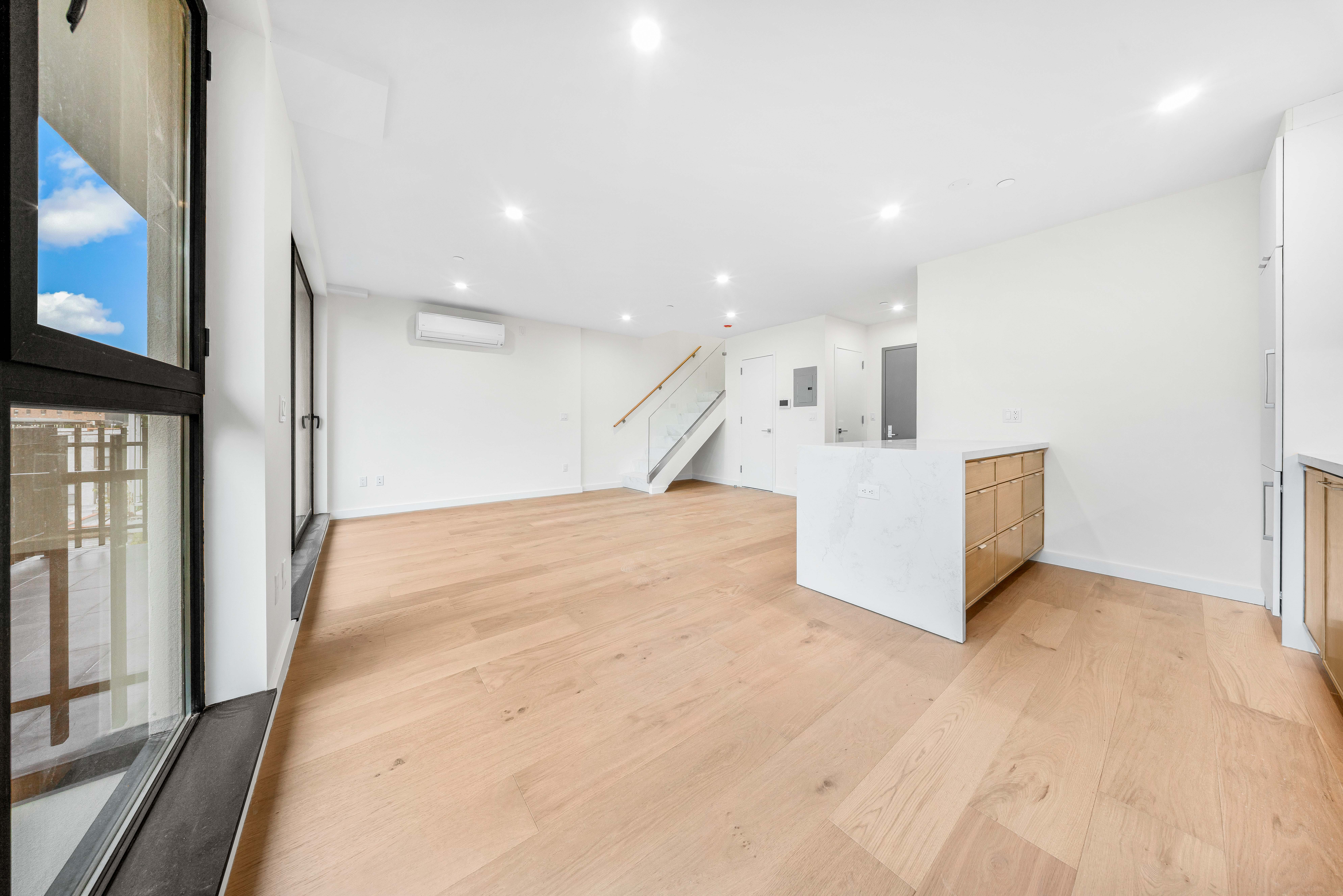30-24 32nd Street, Unit 4A Queens, NY 11102 - Photo 2 of 22 a view of an empty room with wooden floor and a flat screen tv