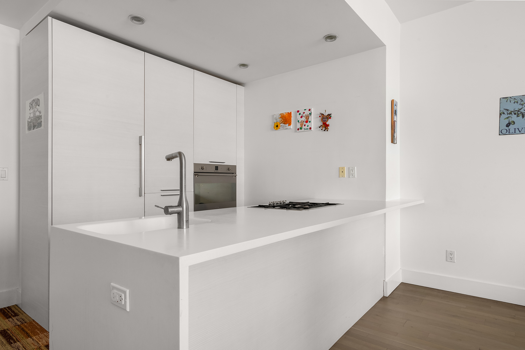 5-19 Borden Avenue, Unit 6C Queens, NY 11101 - Photo 3 of 11 a kitchen with stainless steel appliances a sink and a refrigerator