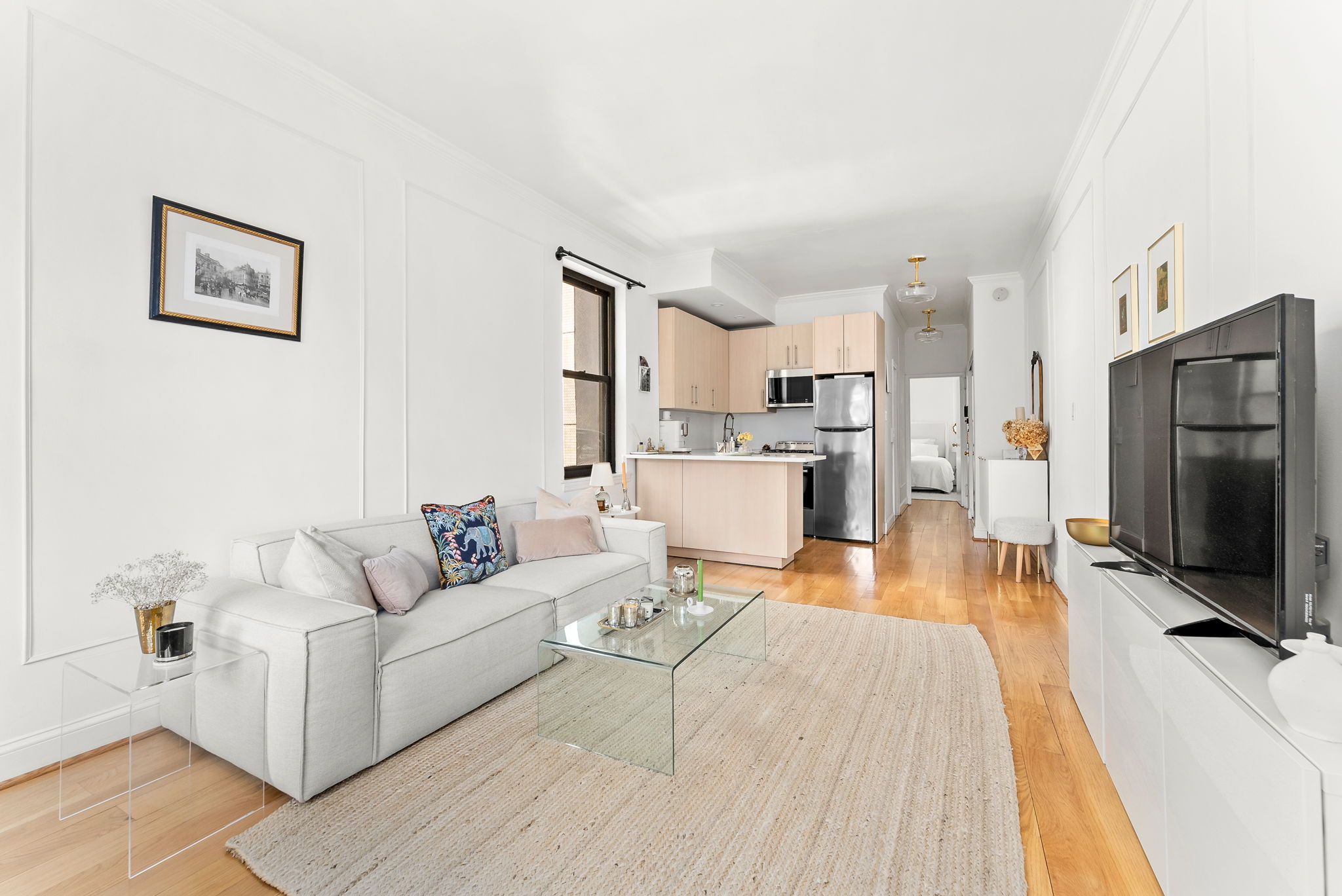 512 East 83rd Street, Unit D4 Manhattan, NY 10028 - Photo 7 of 21 a living room with furniture and a flat screen tv