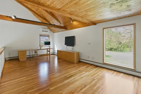 a view of livingroom with wooden floor and flat screen tv