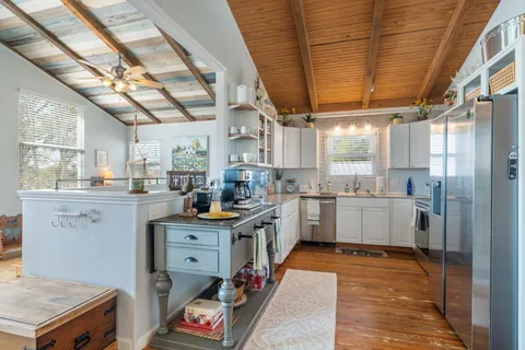 a kitchen with white cabinets and white appliances