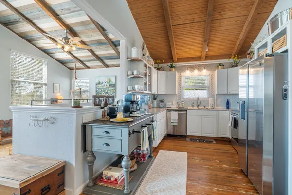 a kitchen with white cabinets and white appliances