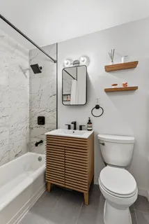 a bathroom with a sink a toilet and bathtub