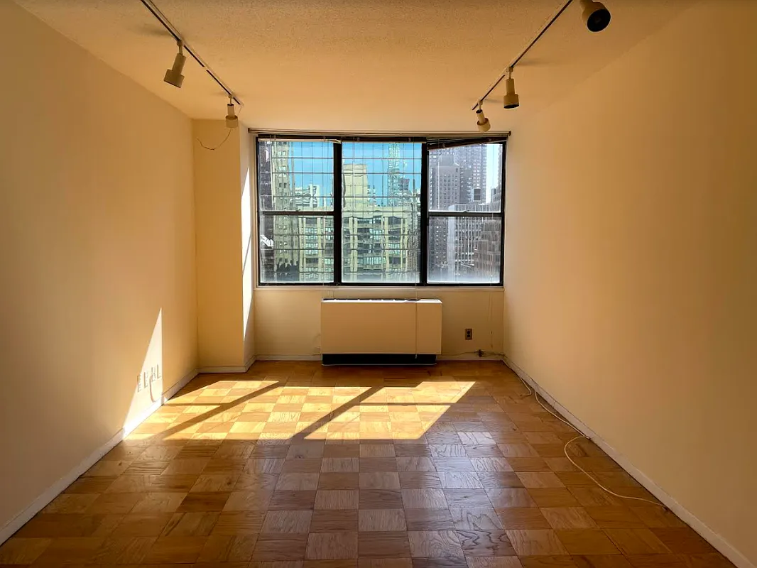301 East 45th Street, Unit 20D Manhattan, NY 10017 - Photo 6 of 8 a view of an empty room with a window