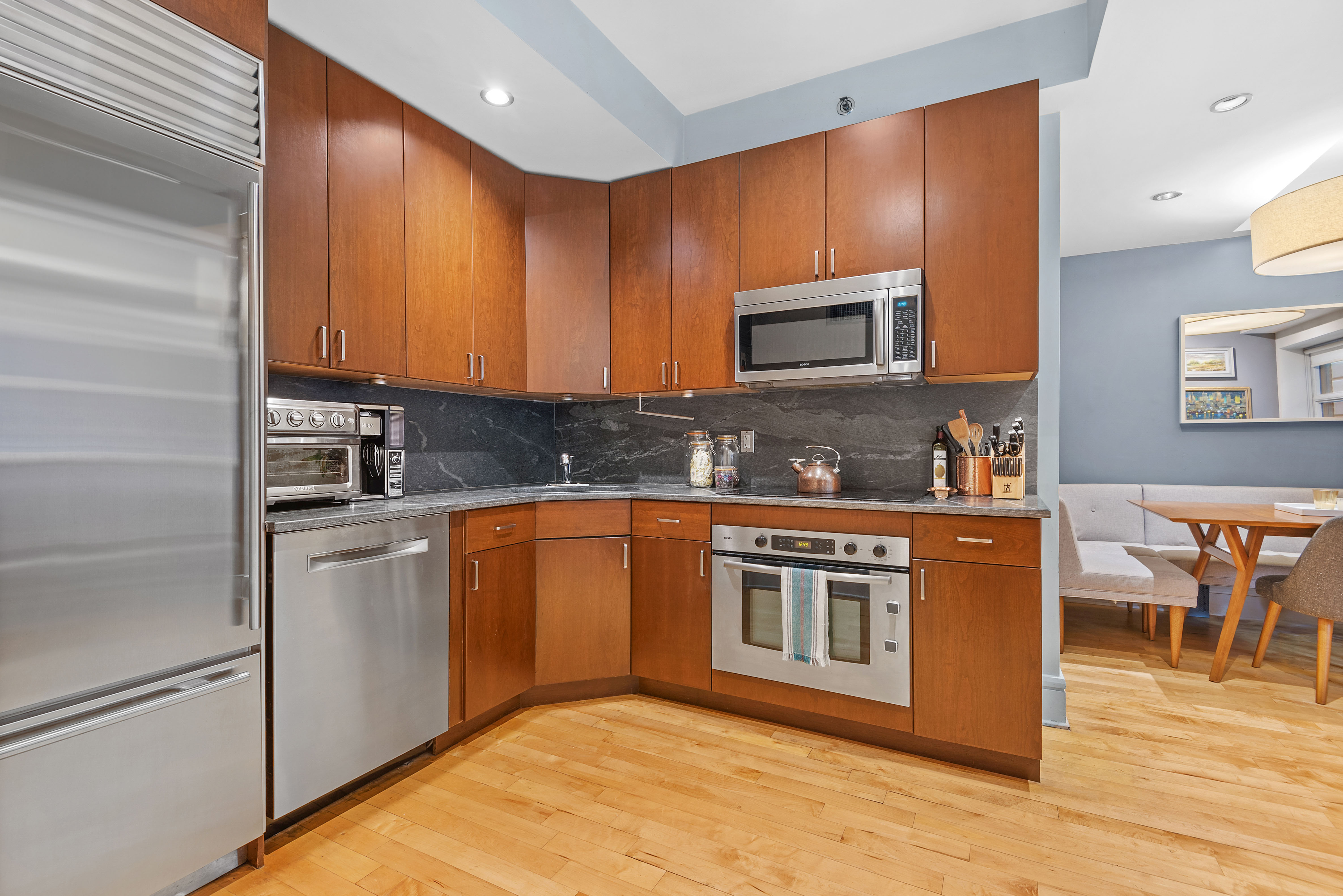 57 Front Street, Unit 305 Brooklyn, NY 11201 - Photo 6 of 10 a kitchen with stainless steel appliances granite countertop a stove a sink and a microwave
