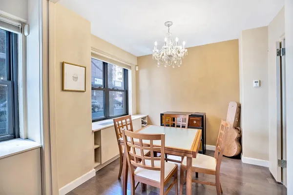 a view of a dining room with furniture and chandelier