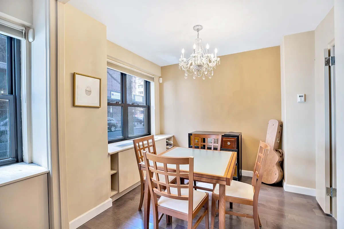 50 Sutton Place South, Unit 2D Manhattan, NY 10022 - Photo 3 of 11 a view of a dining room with furniture and chandelier