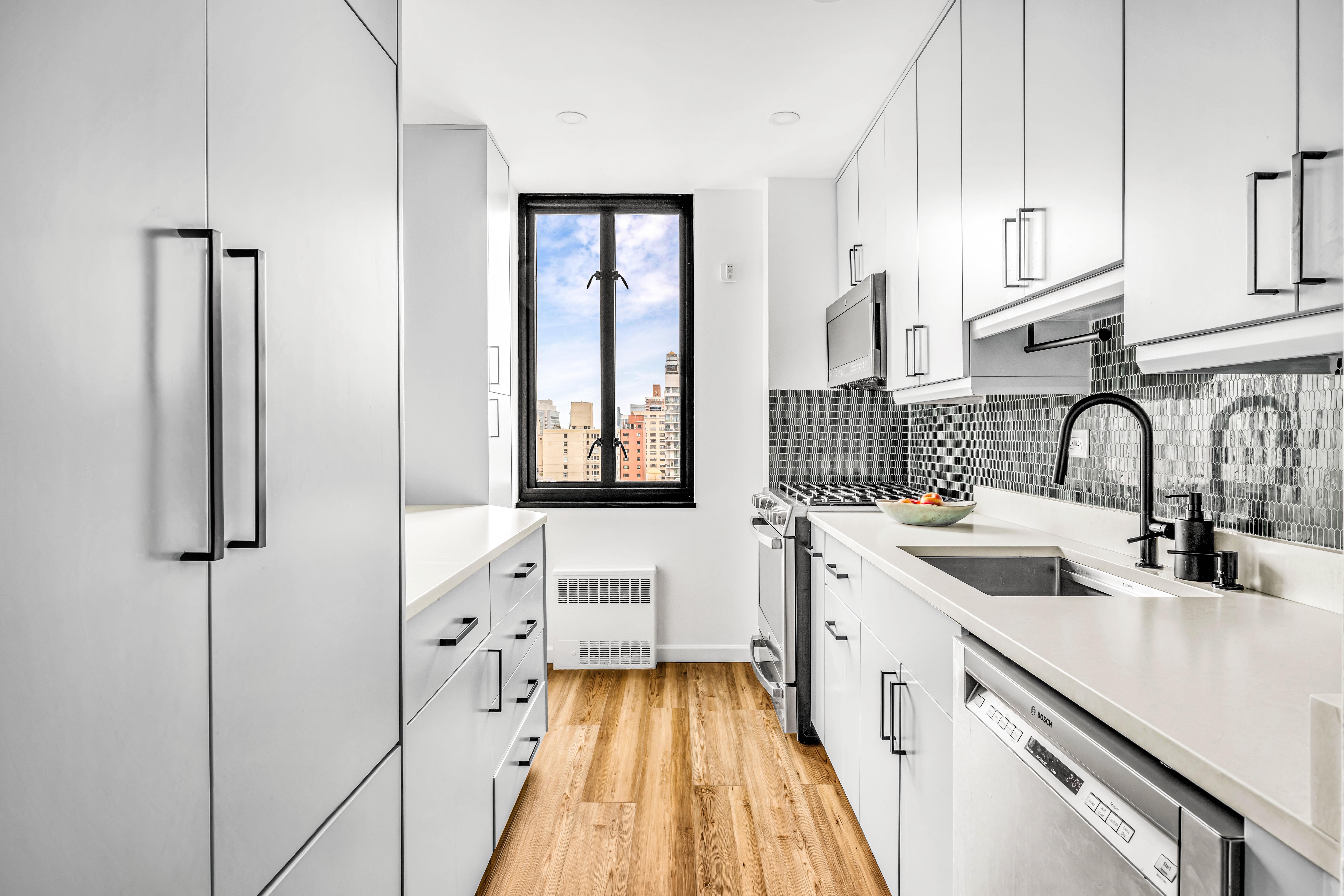 407 Park Avenue South, Unit 18B Manhattan, NY 10016 - Photo 2 of 8 a kitchen with white cabinets and sink