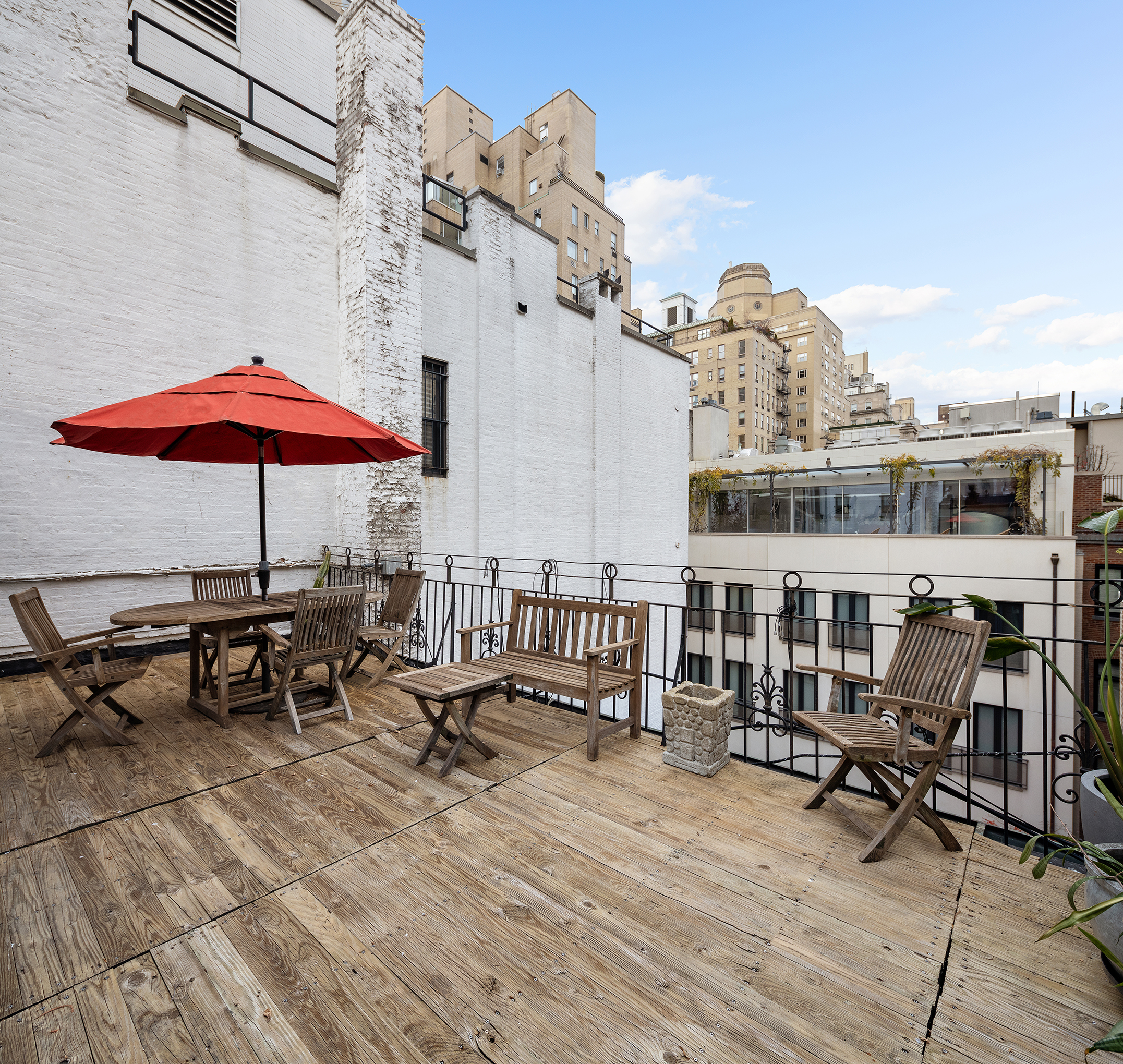 7 East 74th Street, Unit PH Manhattan, NY 10021 - Photo 7 of 10 a view of a rooftop with chairs and table on the terrace