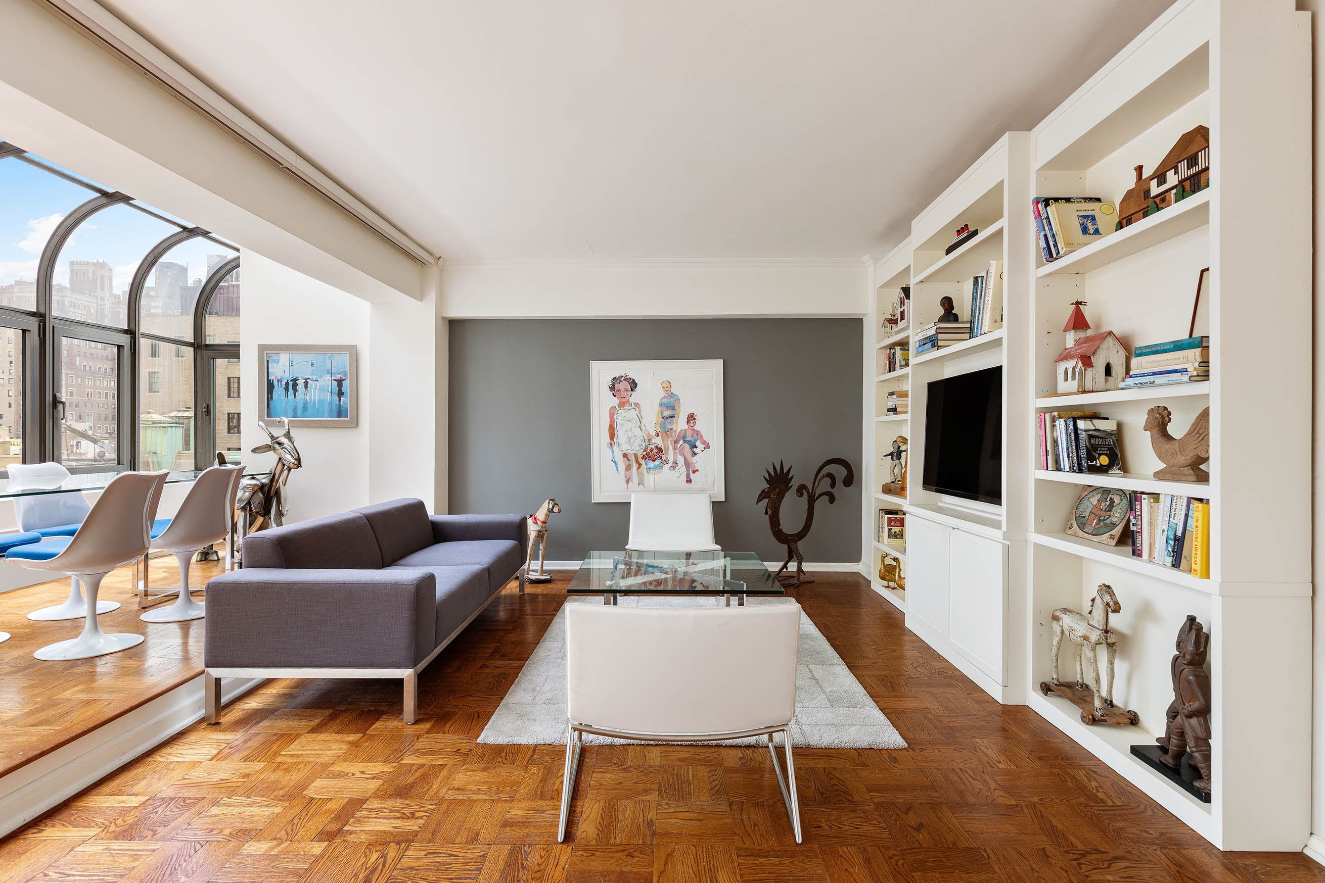 860 5th Avenue, Unit 11E Manhattan, NY 10065 - Photo 3 of 9 a living room with furniture and a flat screen tv