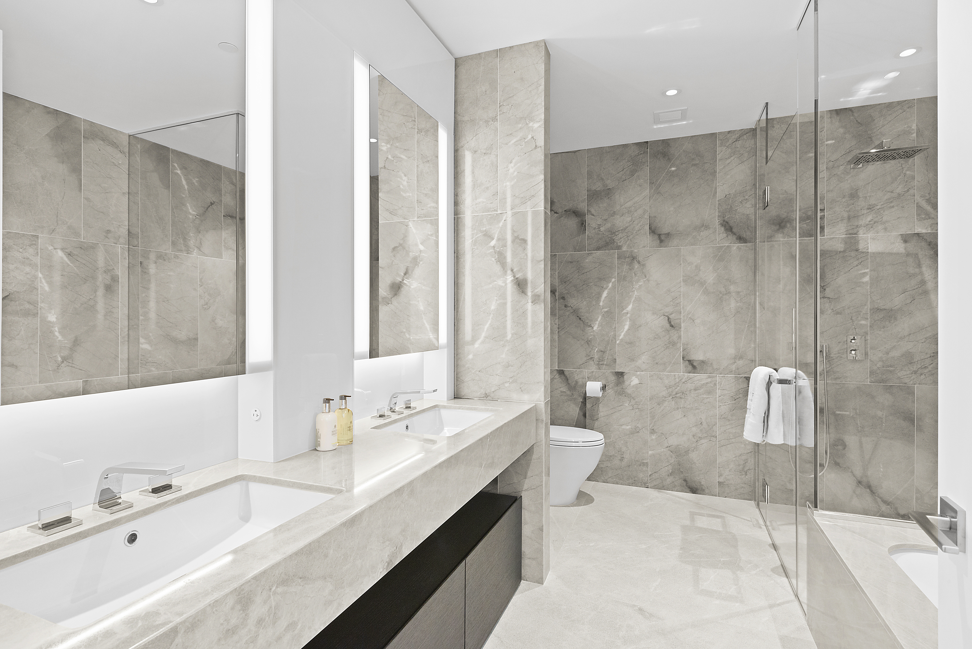 15 Hudson Yards, Unit 26C Manhattan, NY 10001 - Photo 5 of 8 a bathroom with a tub sink and mirror