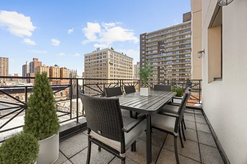 a view of a balcony with a table and chairs
