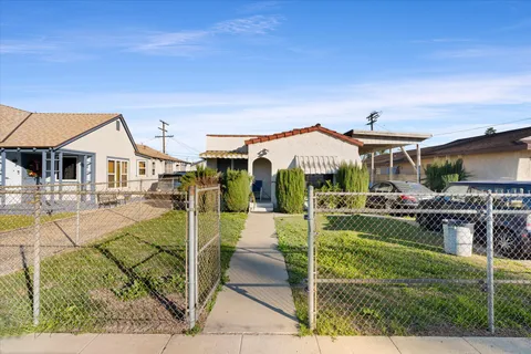 a view of a house with backyard porch and sitting area