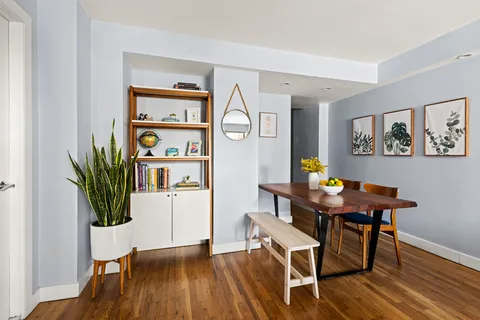 a view of a workspace with furniture and wooden floor