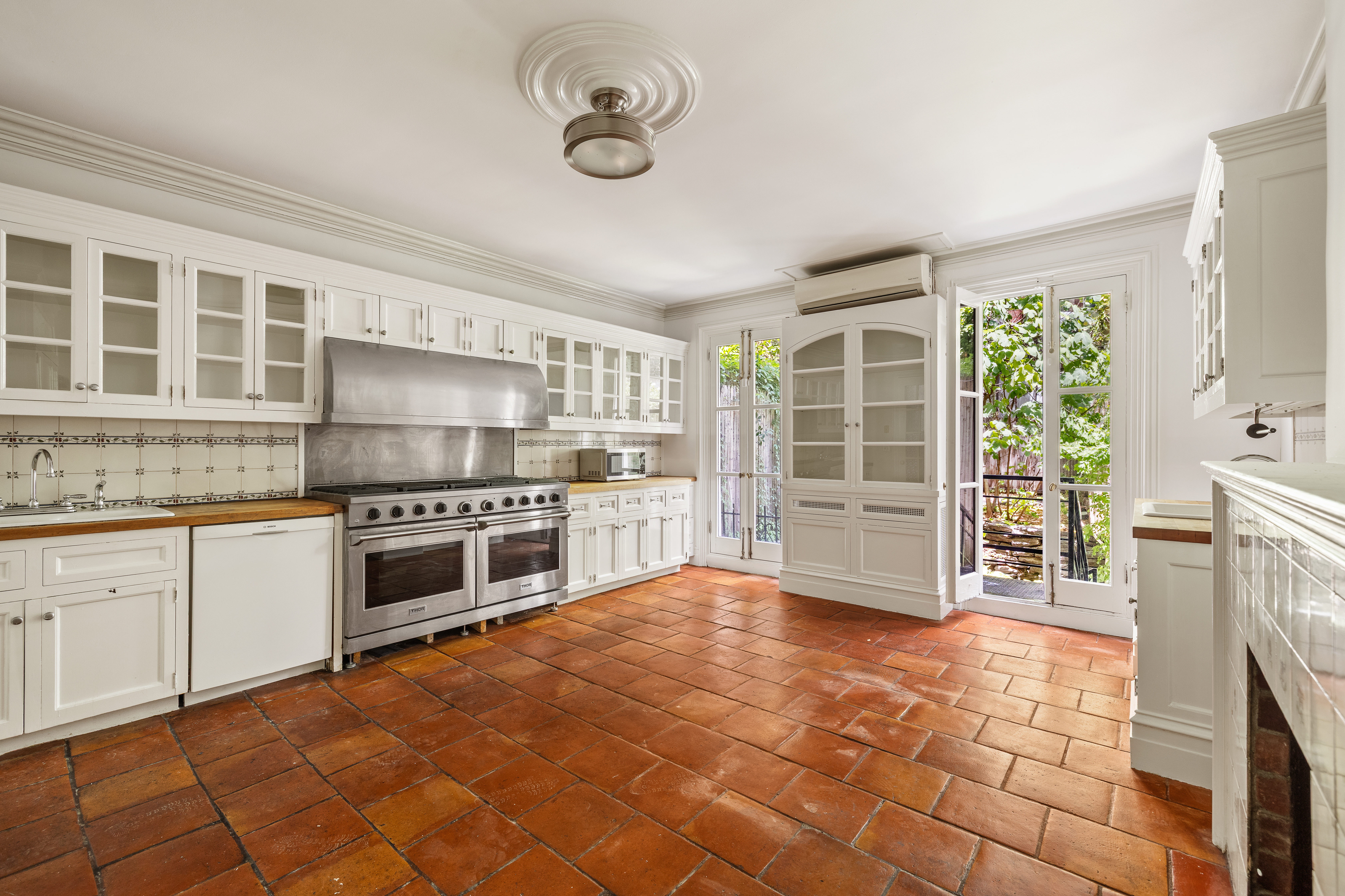 225 West 22nd Street Manhattan, NY 10011 - Photo 3 of 12 a kitchen with stainless steel appliances a stove a sink and cabinets