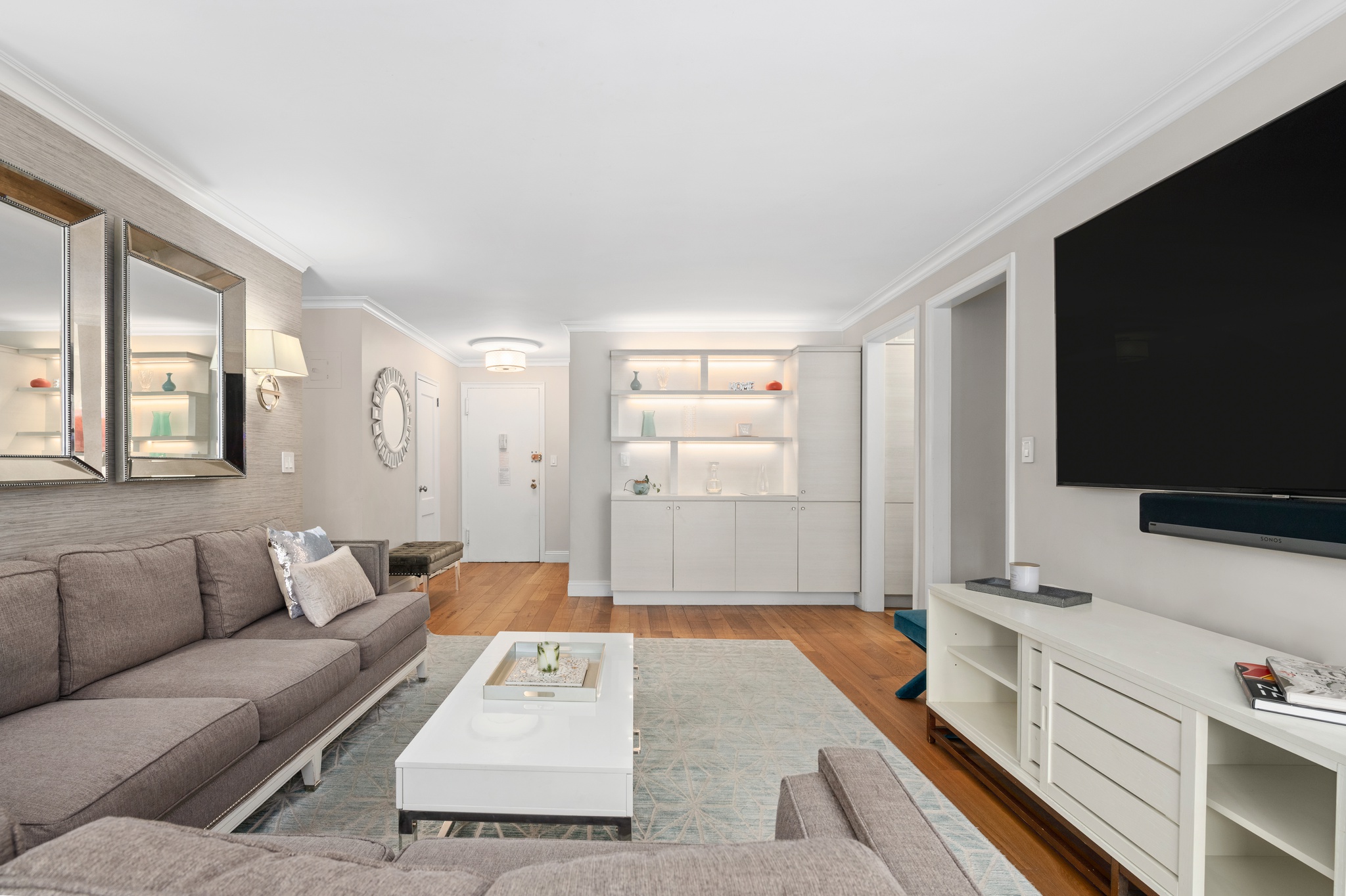 10 West 15th Street, Unit 1027/1028 Manhattan, NY 10011 - Photo 2 of 15 a living room with furniture and a flat screen tv