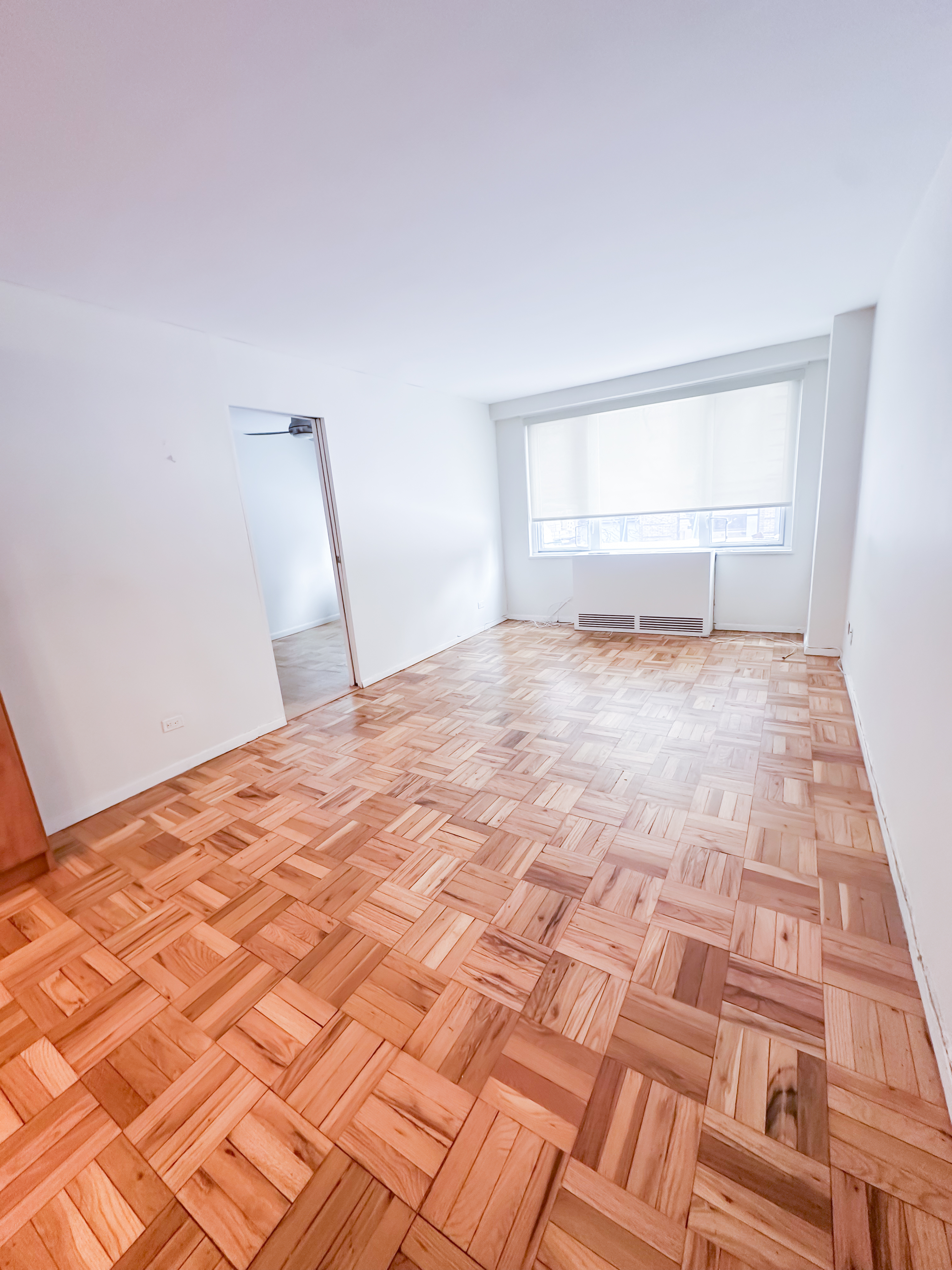 301 East 22nd Street, Unit 2H Manhattan, NY 10010 - Photo 9 of 16 a view of empty room with wooden floor