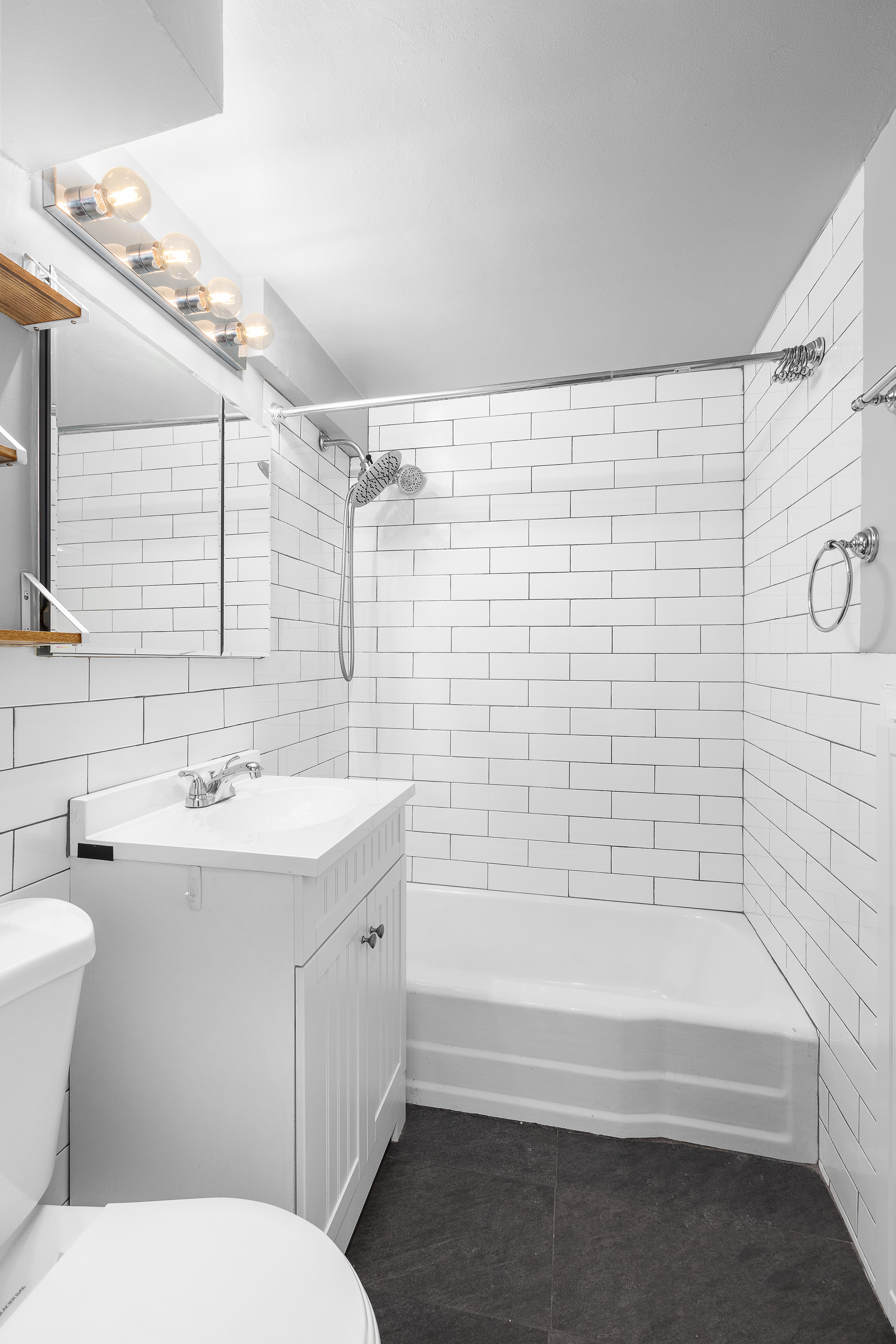 139 East 33rd Street, Unit 15G Manhattan, NY 10016 - Photo 9 of 11 a bathroom with a sink a toilet and shower