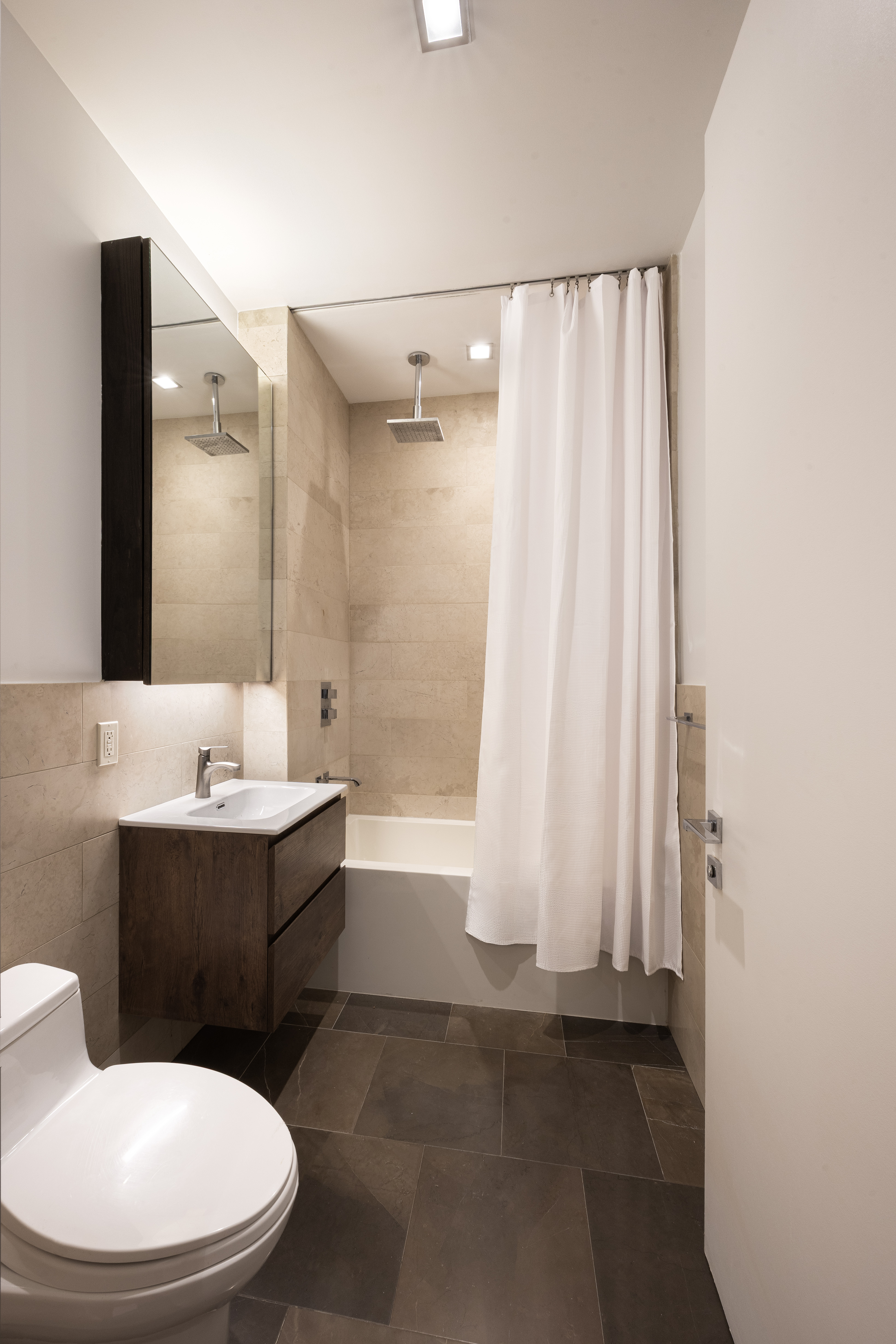 140 West 22nd Street, Unit 2B Manhattan, NY 10011 - Photo 6 of 12 a bathroom with a sink a toilet and tub