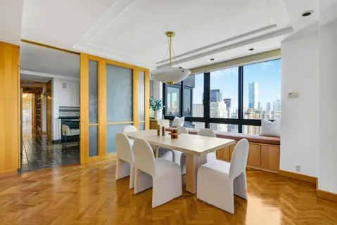 a kitchen with a table chairs and a refrigerator