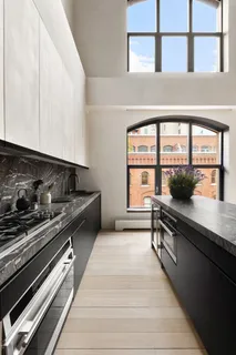 a kitchen with stainless steel appliances a sink stove and cabinets