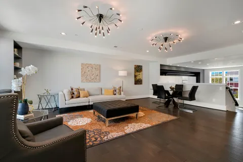 a living room with furniture and a chandelier