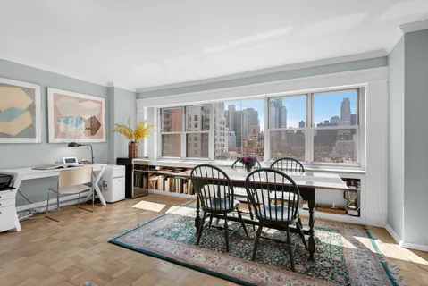 a view of a dining room and livingroom with furniture window and wooden floor